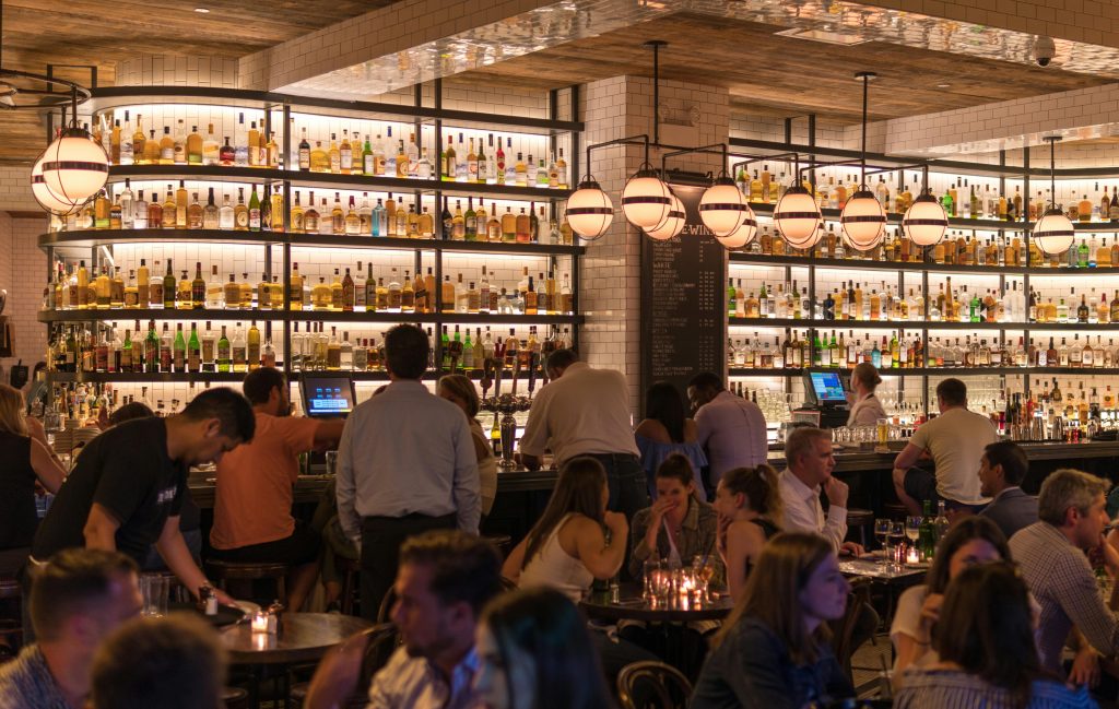 pexels-photo-1058277-1058277 Experience the lively atmosphere of a bustling New York City bar with patrons enjoying nightlife within a stylish indoor setting.